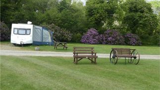 caravan parked next to benches