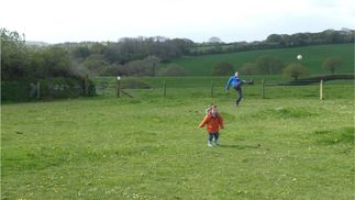 child and father playing on the campsite