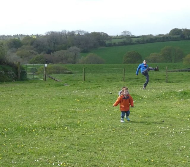 child and father playing on the campsite